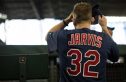 Chase Jarvis stands with his back to camera in a baseball uniform