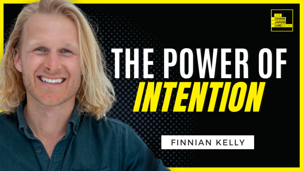 A smiling man with long blonde hair is featured on the left side of the image against a black background with dotted patterns. To the right, bold white and yellow text reads "The Power of Intention," with the name "Finnian Kelly" displayed below. The Chase Jarvis LIVE Show logo is positioned in the upper right corner.