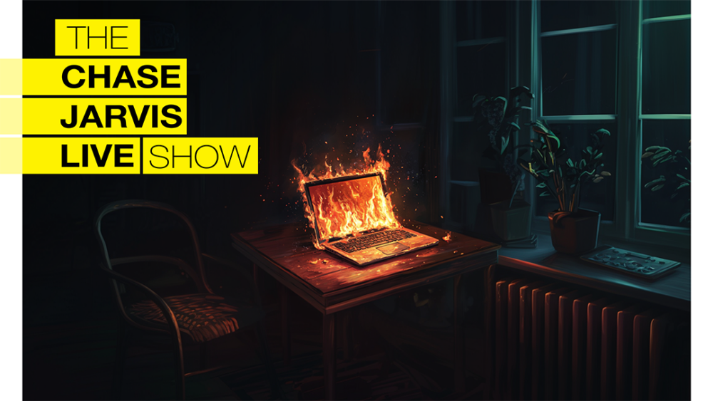 On the left side, the show's logo is prominently displayed, with "THE CHASE JARVIS LIVE SHOW" in bold black text inside yellow rectangles, stacked vertically. To the right of the logo, the image depicts a dark, moody scene inside a room at night. A wooden table is at the center, on which a laptop is placed. The laptop is on fire, with flames engulfing the screen and keyboard, casting a warm glow on the surrounding area. The room has large windows with potted plants on the windowsill, and there is a radiator beneath the window. The lighting in the room contrasts with the fire's bright, intense glow, creating a dramatic effect.