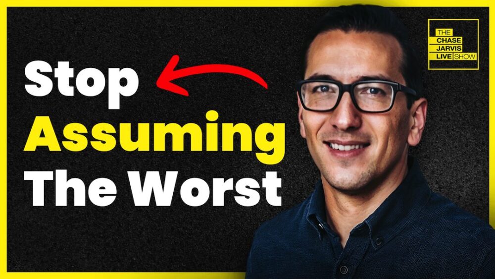 The left side features bold text that reads: "Stop Assuming The Worst" The text "Stop" and "The Worst" are in bold white font, while "Assuming" is in bold yellow font. The phrase "Stop" is emphasized with a red arrow pointing to the right. On the right side of the image, there is a photo of a smiling man wearing glasses and a dark shirt, looking directly at the camera. The show's logo is positioned in the top right corner, featuring "THE CHASE JARVIS LIVE SHOW" in black text inside yellow rectangles. The entire graphic is framed with a yellow border, which matches the color scheme of the text and logo. The background is a dark, textured surface that adds contrast to the bright text and imagery.